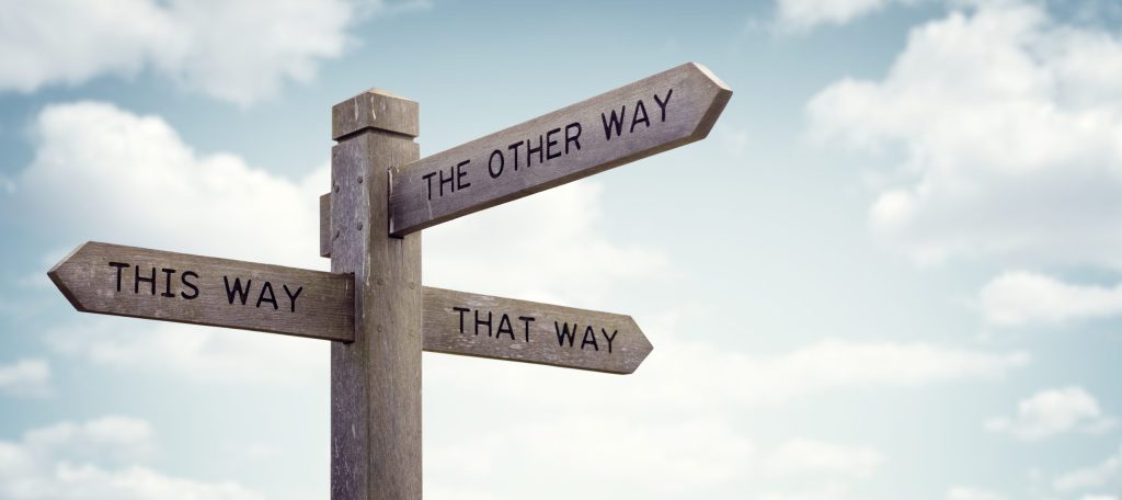 Road sign pointing in different directions